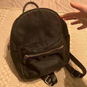 mini black backpack perfect condition with gold buckle and zipper detail
